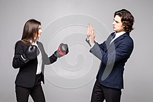 Business people boxing concept. The fight between the two investors. Business couple fight. Woman in box gloves fight with man