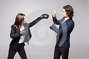 Business people boxing concept. The fight between the two investors. Business couple fight. Woman in box gloves fight with man