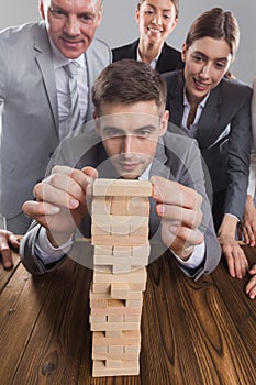 Business people building wood tower