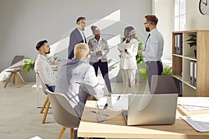 Business people chatting on meeting. Company employees talking in office. Team work concept.