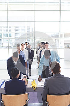 Business people checking in at conference registration table