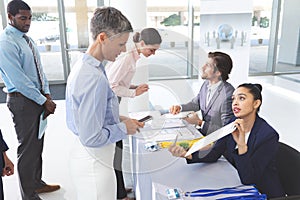 Business people checking in at conference registration table