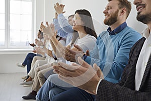 Business people clapping and applause at meeting or conference, close-up of hands. Group of businessmen and women in