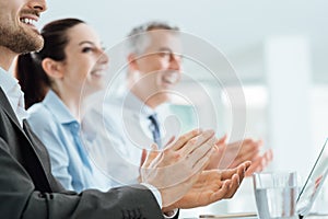 Business people clapping hands during a seminar