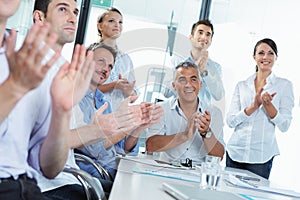 Business people clapping in a meeting