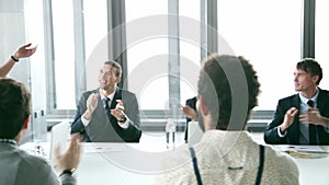 Business people clapping on a meeting in conference room