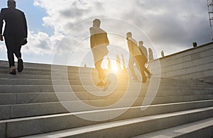 Business people climb the steps of the city stairs. impersonal rising up. Career growth and advancement. Increasing and