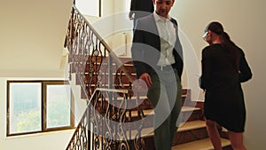 Business people climbing stairs in finance corporate building