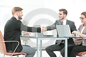 Business people closing a deal and handshaking at the office