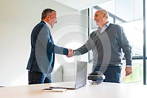 Business people closing a deal about an innovative mixed reality goggles