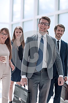 Business people confidently walking in a modern office building