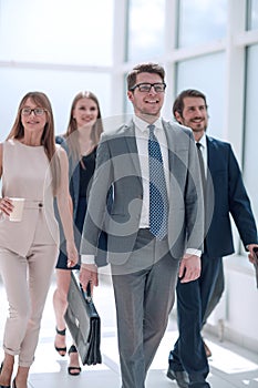 Business people confidently walking in a modern office building