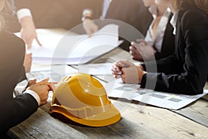 Business people with construction blueprint