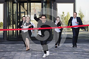 Business people crossing the finish line