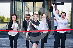 Business people crossing the finish line