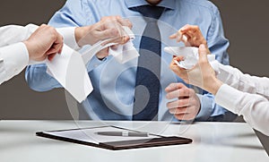 Business people cruelly tearing documents