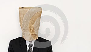 Business people with crumpled brown paper bag on head, with copy space