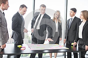 Business people developing plan on office desk