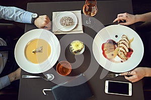 Business People Dining Together Concept, Grilled pork tenderloin with pomegranate souce and potato and cream soup