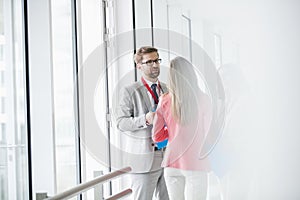 Business people discussing in brightly lit convention center