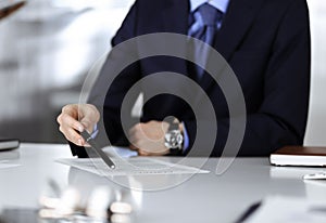 Business people, discussing a contract, working together at meeting, sitting at the desk in a modern office. Unknown