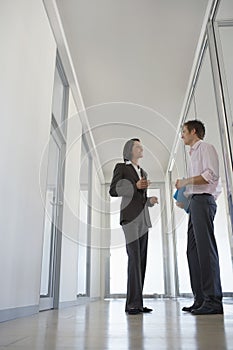 Business People Discussing In Corridor