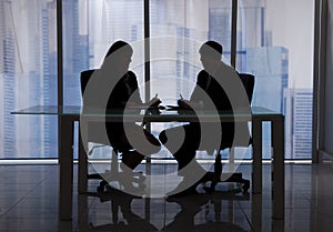 Business people discussing at desk in office