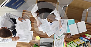 Business people discussing and looking for financial report in office top view