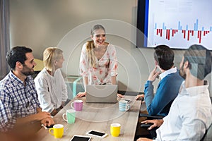 Business people discussing over graph during a meeting