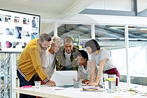 Business people discussing over laptop in the conference room