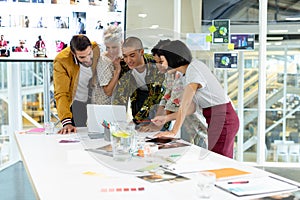 Business people discussing over laptop in the conference room