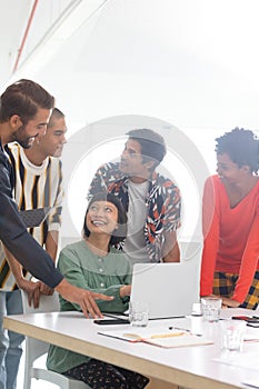 Business people discussing over laptop in the conference room