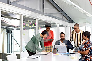 Business people discussing over laptop in the conference room