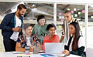 Business people discussing over laptop in the conference room