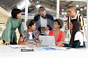 Business people discussing over laptop in the conference room