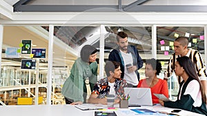 Business people discussing over laptop in the conference room