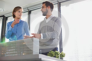 Business people discussing over new building structure plan in office