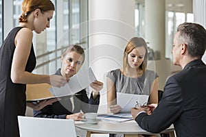 Business people doing paperwork in office cafeteria