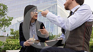 Business people eating a meal outside office