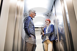 Business people in the elevator in modern office building.