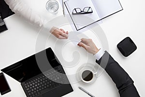 Business People Exchanging Visiting Card At Office Desk