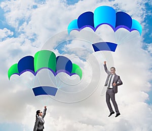 Business people falling down on parachutes