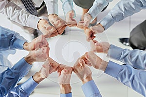 Business people, fist circle and teamwork in low angle, team building and trust in office.