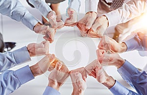 Business people, fist circle and teamwork in low angle, team building and trust in office.
