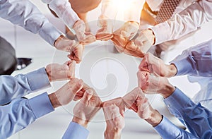 Business people, fist circle and teamwork in low angle, team building and trust in office.