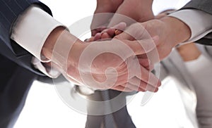 Business people folding their hands together.