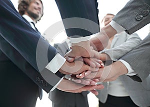 Business people folding their hands together.