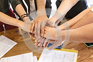 Business people folding their hands together