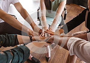 Business people folding their hands together