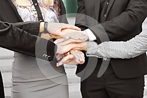Business people folding their hands together.concept of teamwork